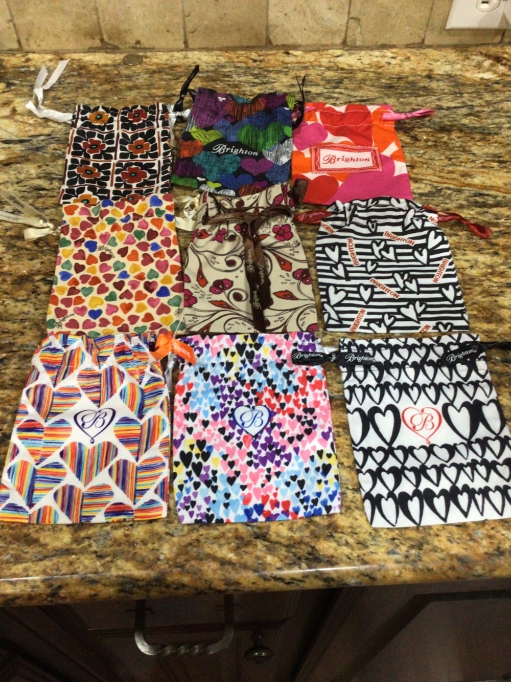 Nine signature Brighton Jewelry bags. All in good shape.